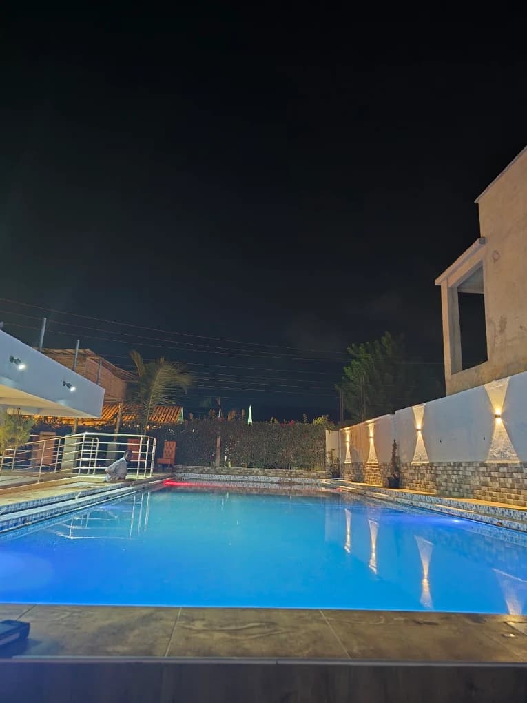 Sensera Gardens illuminated pool and garden grounds at night